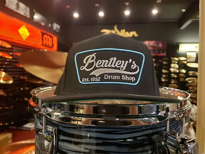 Bentley’s Drum Shop Clothback Snapback Hat Black w/ Blue and White Logo