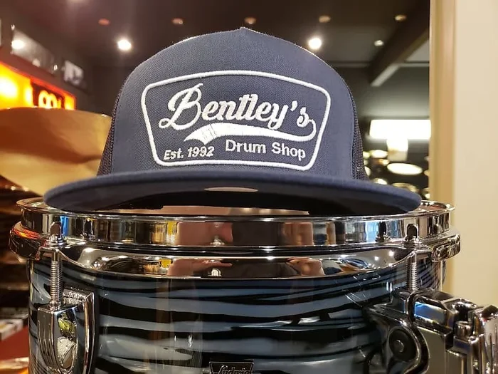 Bentley’s Drum Shop Trucker Snapback Hat in Navy Blue